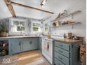 Cozy kitchen with blue cabinets, open shelving and rustic wood accents at 116 E Railroad St, Fountaintown, IN 46130