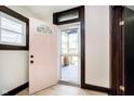A welcoming entryway with a pink front door and neutral walls at 1402 Olive St, Indianapolis, IN 46203