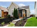 Charming single-story home with a well-maintained lawn and inviting front porch at 1402 Olive St, Indianapolis, IN 46203