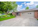 Attractive home with an attached garage and beautifully landscaped front yard at 143 Asbury Dr # 86A, Anderson, IN 46013