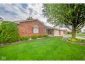 Charming single-story brick home with tidy front lawn and inviting curb appeal at 143 Asbury Dr # 86A, Anderson, IN 46013