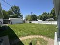 Spacious backyard featuring a well-kept lawn and a detached garage at 144 Bel Aire Dr, Whiteland, IN 46184
