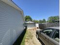 Gravel driveway leading to a detached garage, offering ample parking space at 144 Bel Aire Dr, Whiteland, IN 46184