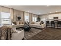 Open-concept living room with hardwood floors, ample natural light, and stylish furniture at 1614 N Clearwater Dr, Greenfield, IN 46140