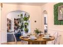Bright dining room features stylish decor, decorative archways, and seating for six around a round table at 1709 E Loretta Dr, Indianapolis, IN 46227