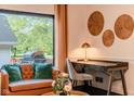 Comfortable living room seating area with desk, stylish decor, and natural light from backyard window at 1709 E Loretta Dr, Indianapolis, IN 46227