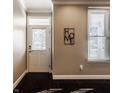 Welcoming entryway with dark hardwood floors, a decorative wall sign, and a bright window with blinds at 2016 Central Ave, Indianapolis, IN 46202
