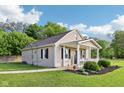 This cozy home features a welcoming front porch, tidy landscaping, and a well-maintained lawn at 2025 E Broadway St, Fortville, IN 46040