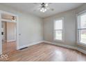 Bright living room with hardwood floors, neutral paint and ample natural light from the many windows at 2154 Barth Ave, Indianapolis, IN 46203