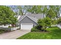 Lovely house exterior with lush trees, a white fence, and a well-kept lawn at 3602 Bay Rd S Dr, Indianapolis, IN 46240
