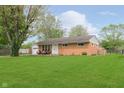 Charming brick ranch home with a lush green lawn and inviting front porch at 3723 S Dearborn St, Indianapolis, IN 46237