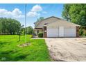 Charming two-car garage with well-manicured lawn and beautiful landscaping at 4505 Stratford Dr, Anderson, IN 46013
