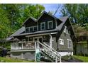 Charming home with a well-maintained lawn, inviting front porch, and lush, mature trees in a neighborhood setting at 455 E Main St, Danville, IN 46122