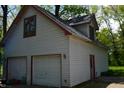 Spacious two-car garage featuring red trim, offering ample parking and storage solutions at 455 E Main St, Danville, IN 46122
