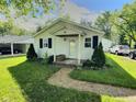 Cozy single-story home with a covered front porch and well-maintained lawn at 4986 Adkins St, Columbus, IN 47201