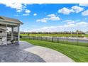 Concrete patio overlooking a fenced backyard, offering serene views of the pond and surrounding community at 5248 Holborn Ave, McCordsville, IN 46055