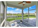 Relaxing screened-in patio with decorative floor offers scenic views of the community pond at 5248 Holborn Ave, McCordsville, IN 46055