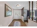 Inviting entryway with double doors, beautiful floors, and decorative wood accents at 5312 Larita Ln, Anderson, IN 46017