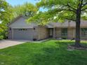 Charming single-story home with a well-maintained lawn and attached two-car garage at 5361 Carnoustie Cir, Avon, IN 46123