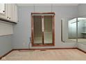 A room with a window, wood trim, and a mirror reflects additional space at 5361 Carnoustie Cir, Avon, IN 46123