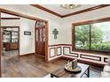 Elegant entryway with hardwood floors, decorative molding, and a charming wooden door with glass panels at 5377 Crooked Stick Ct, Greenwood, IN 46142