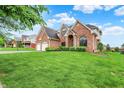 Beautiful two-story brick home with a well-maintained lawn and mature trees in a quiet neighborhood at 5377 Crooked Stick Ct, Greenwood, IN 46142