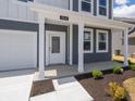 Close-up of the home's entry, highlighting the covered porch and well-kept landscaping at 5540 Tart Blvd, Indianapolis, IN 46239