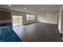 Bright, spacious kitchen area with sliding glass doors, multiple windows, and modern gray cabinets and countertops at 5540 Tart Blvd, Indianapolis, IN 46239