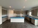 Well-lit kitchen featuring modern gray cabinets, a center island, and sleek countertops with protective covering at 5540 Tart Blvd, Indianapolis, IN 46239