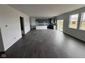 An open-concept living area with dark wood-look floors and ample natural light from windows and sliding glass door at 5540 Tart Blvd, Indianapolis, IN 46239