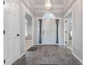 Inviting foyer with tiled flooring, arched doorway, and ample natural light streaming through the front door at 5601 W Sun Point Dr, Muncie, IN 47304