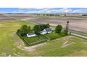 Aerial view of the house with a detached garage and a fenced yard surrounded by open fields at 5855 S 25 W, Lebanon, IN 46052
