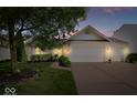 Charming single-Gathering home featuring an attached two-car garage, well-maintained lawn, and mature trees at 5893 Crosscut Ln, Noblesville, IN 46062