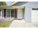 Close-up of the home's entryway, with a white front door, sidelight window, and an attached one-car garage at 5938 Dunseth Ct, Indianapolis, IN 46254