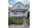 Traditional home with front gate access, a quaint porch with decorative columns, windows, and exterior paint at 616 N Exeter Ave, Indianapolis, IN 46222