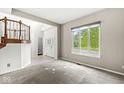 Bright living room with large windows offering ample natural light and a view of the outdoors at 6818 Bluffridge Dr, Indianapolis, IN 46278
