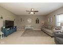 Comfortable living room with ceiling fan, gray sofa, and bright natural light at 7140 Lakeland Trails Blvd, Indianapolis, IN 46259