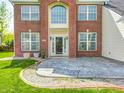 The front exterior offers brick accents, manicured garden, and a concrete patio leading to the main door at 725 Bristle Lake Dr, Brownsburg, IN 46112