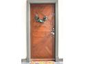Stylish wooden unit door with wreath and number, creating an inviting and personalized entry to the home at 735 Lexington Ave # 23, Indianapolis, IN 46203