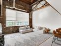 A spacious living area with exposed brick, large windows, and comfortable seating, creating a cozy atmosphere at 735 Lexington Ave # 23, Indianapolis, IN 46203