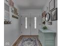 Inviting entryway with double doors, hardwood floors, and stylish decor creating a warm ambiance at 748 Woodcreek Ct, Greenwood, IN 46142