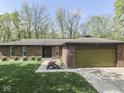 Beautiful brick home with an attached garage and a well-maintained lawn in a desirable neighborhood at 748 Woodcreek Ct, Greenwood, IN 46142