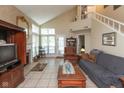Spacious living room with high ceilings, fireplace, and staircase to the second floor at 7608 Harbour, Indianapolis, IN 46240