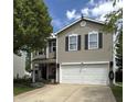 Charming two-story home featuring neutral siding, black shutters, and a well-maintained front yard with mature trees at 98 Frostwood Ln, Greenwood, IN 46143