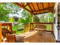 Inviting outdoor seating area with wooden railing and scenic views of lush greenery at 1240 E 56Th St, Indianapolis, IN 46220