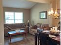 A cozy living room with hardwood floors, neutral walls, comfortable sofas, and a bright, inviting atmosphere at 14058 Southwood Cir, Fishers, IN 46037