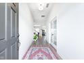 Inviting entryway with hardwood floors, a colorful rug and lots of natural light at 15792 Wiseman Dr, Fishers, IN 46040