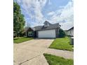 Charming single-story home featuring a spacious driveway, two-car garage, and well-maintained lawn at 1639 Park Castle Way, Indianapolis, IN 46229