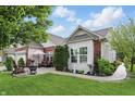 Enjoy the outdoor patio with chairs and a fire pit, surrounded by green landscaping at 1663 Sweetgum Dr, Greenwood, IN 46143