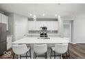 Modern kitchen with white cabinets, stainless steel appliances, and a large center island with seating at 16739 Cattle Hollow Ln, Noblesville, IN 46060